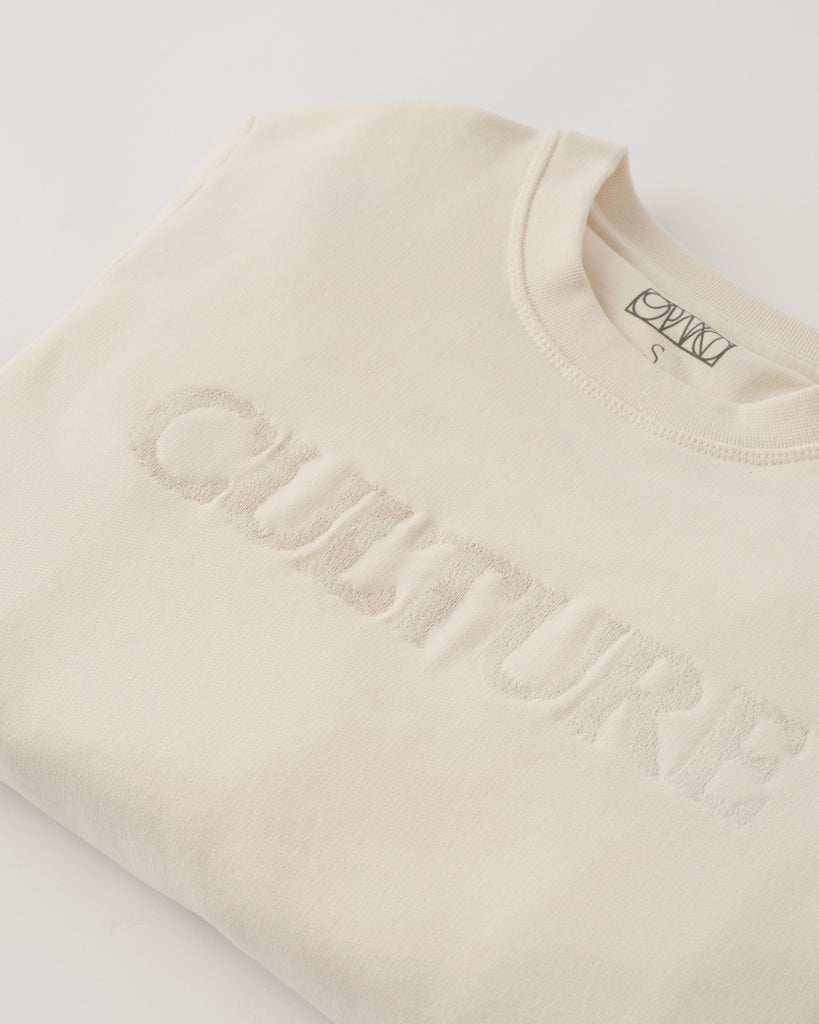 Beige sweatshirt with 'Quasture' branding on a light gray background