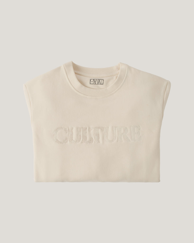 Beige sleeveless sweatshirt with 'CULTURE' text on a light gray background